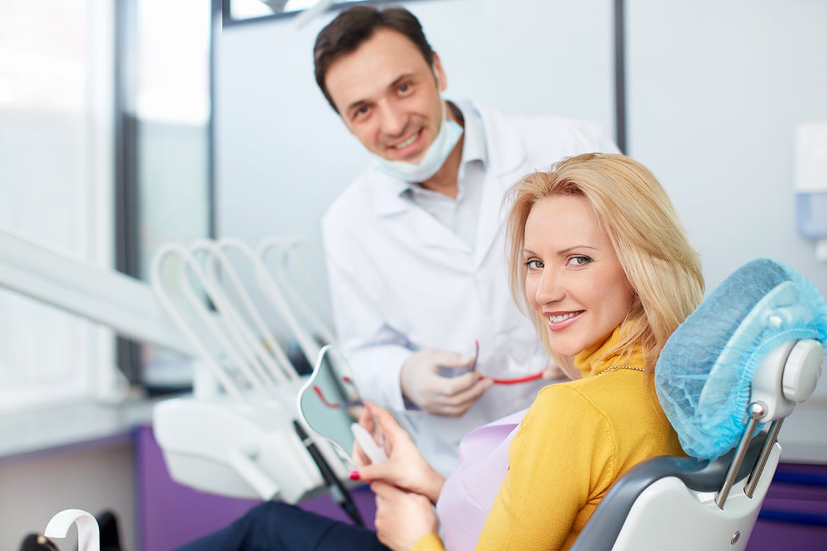 female patient and male dentist discussing how to get whiter teeth and how to get perfect teeth