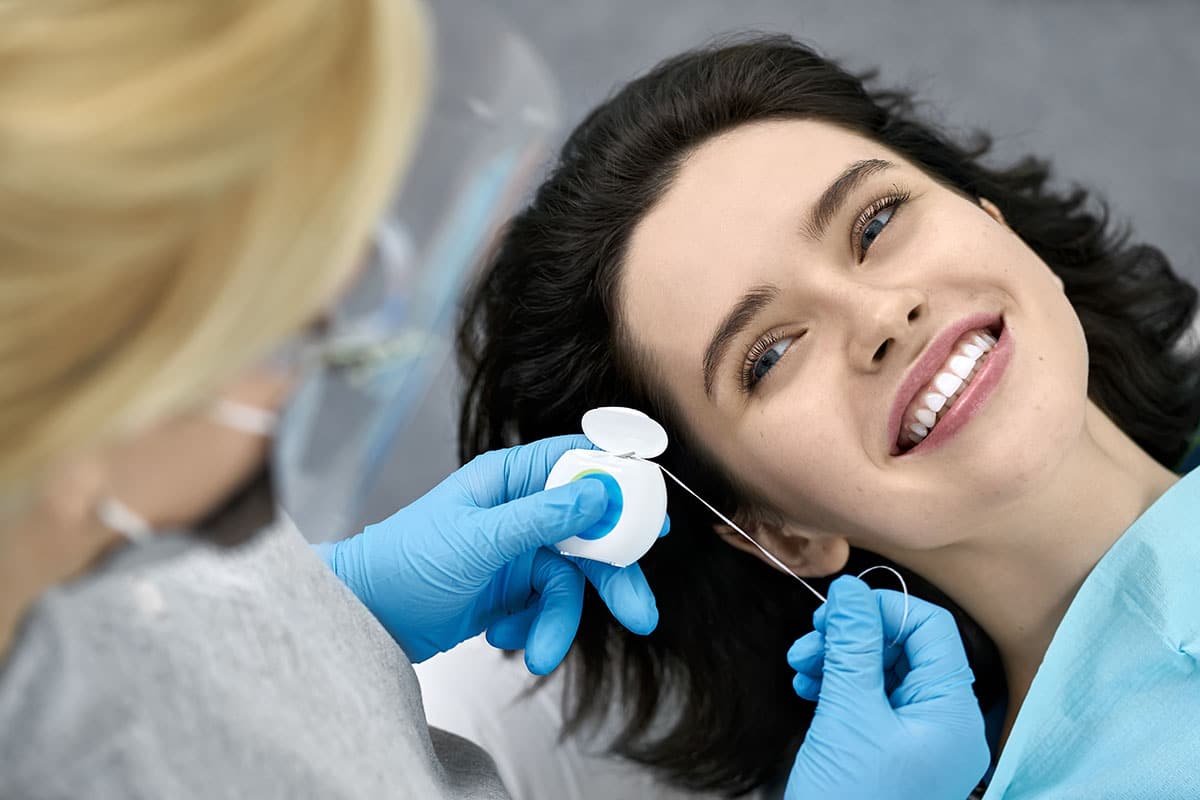 a woman in the dentist chair Teeth Cleaning Rogers Arkansas
