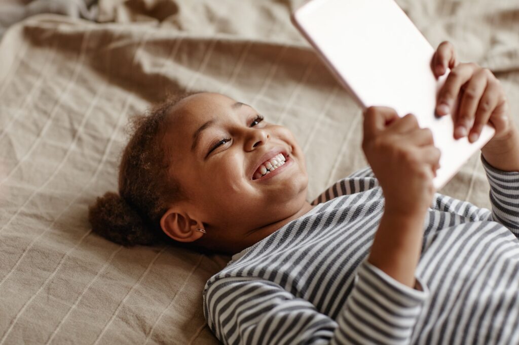 Smiling Little Girl Using Tablet